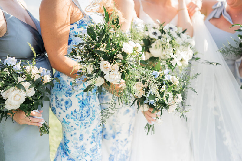 florals the bride and bridesmaids are holding at inn at longshore wedding