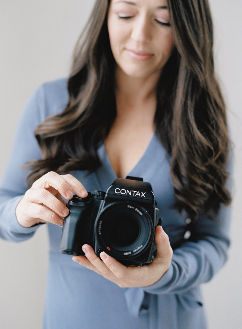 female photographer holding contax 645 medium format film camera