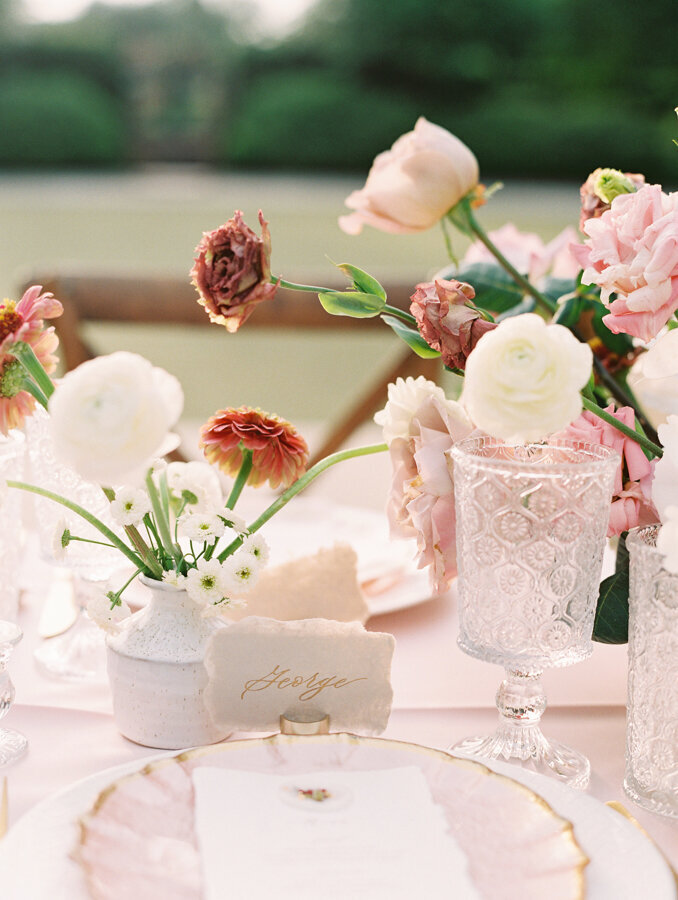 Wedding table setting with a pink floral arrangement