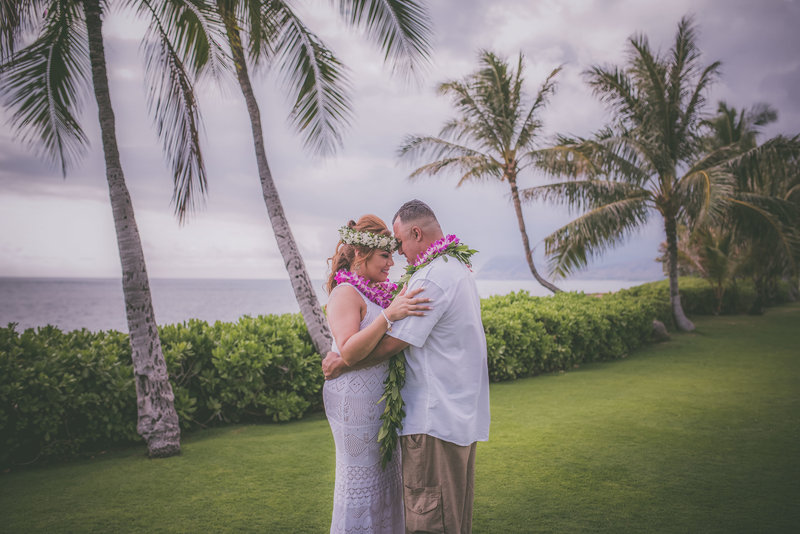 This couple celebrates in Oahu during their vow renewal ceremony.