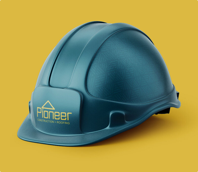 Teal hardhat with Pioneer Construction logo on the front, sitting on a yellow background.