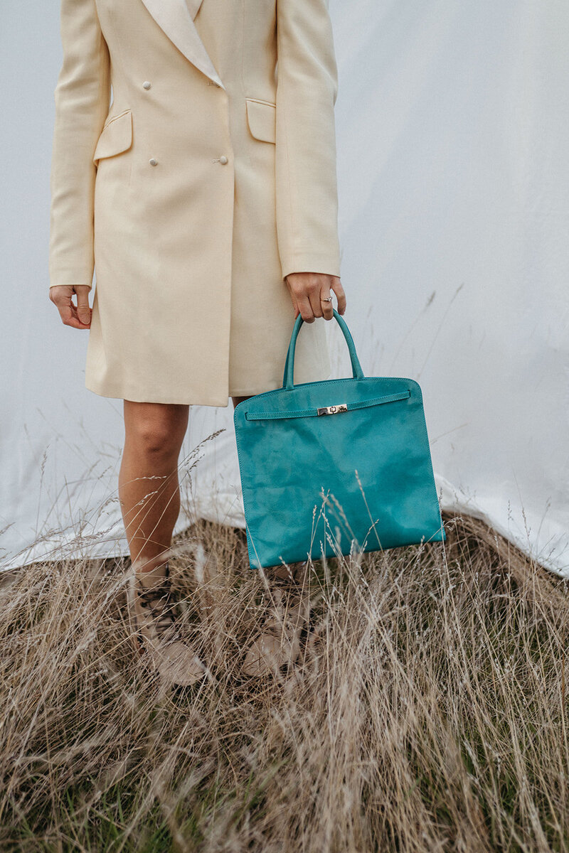 The front of a small store with a sign overhead that reads "Consign Couture est. 2011"