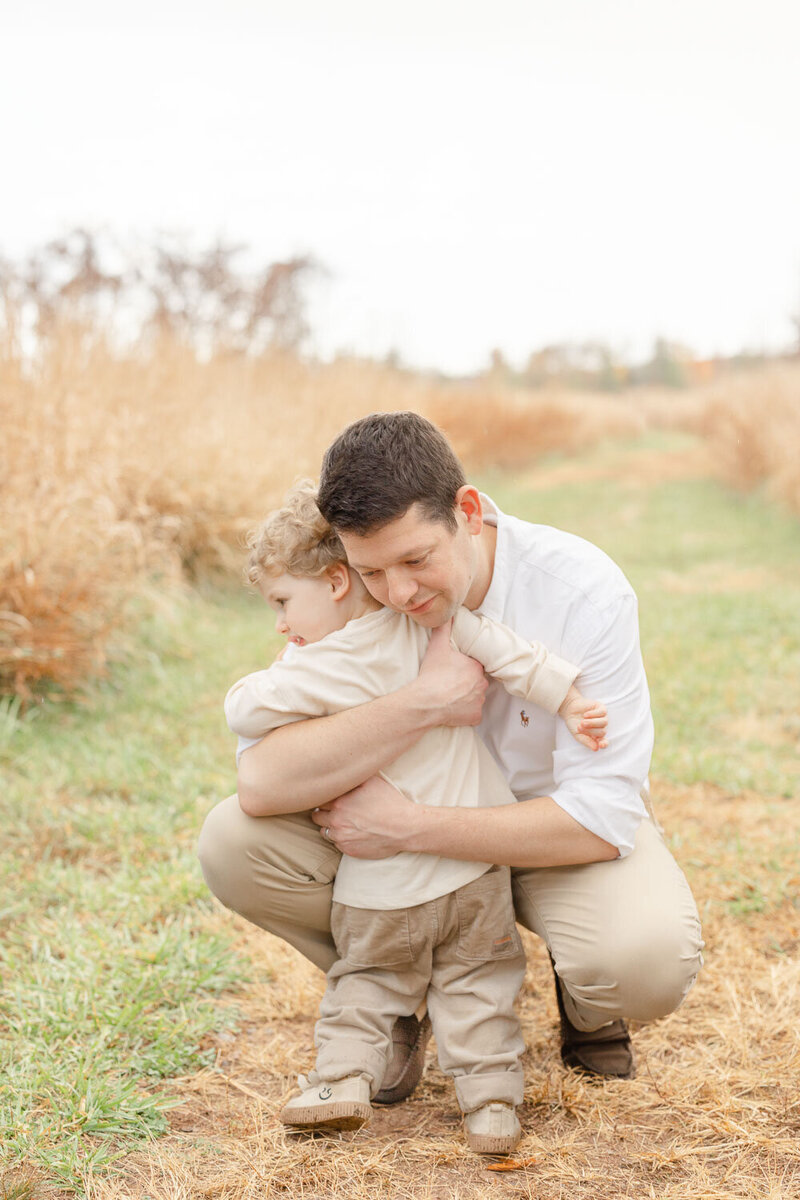 Dad hugging son taken by a Manassas, Virginia photographer