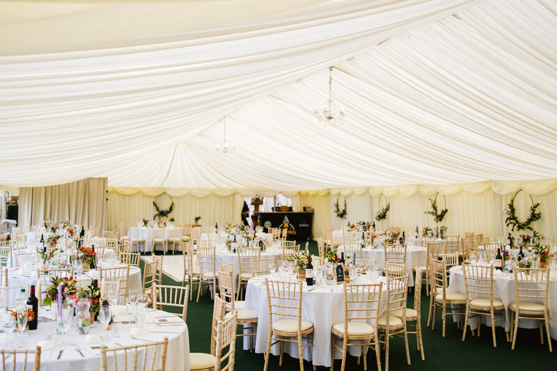 Classic white and gold wedding table decor for an outdoor tent wedding