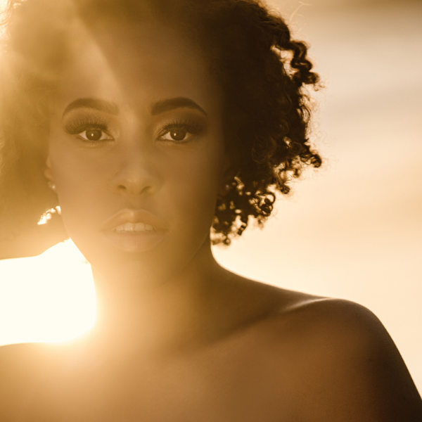 black teen girl with light behind her in a stunning senior portrait in malibu by renee bowen photographer