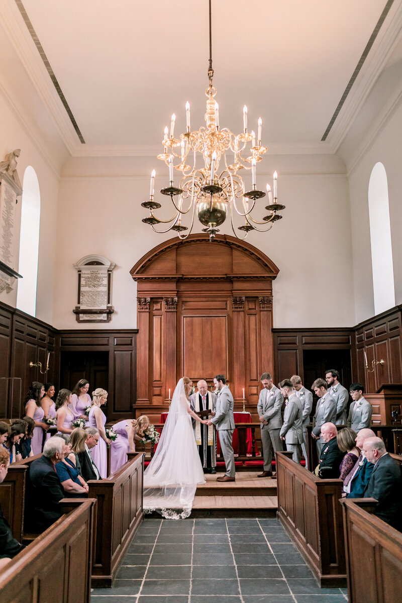 Bride and groom at the altar of Wren Chapel during a Williamsburg wedding planned by Sweet Caroline Events. Photo by Morgan Renee Photography.
