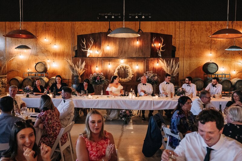 wide shot of wedding reception at bangor farm in darfield with wood walls and concrete floor