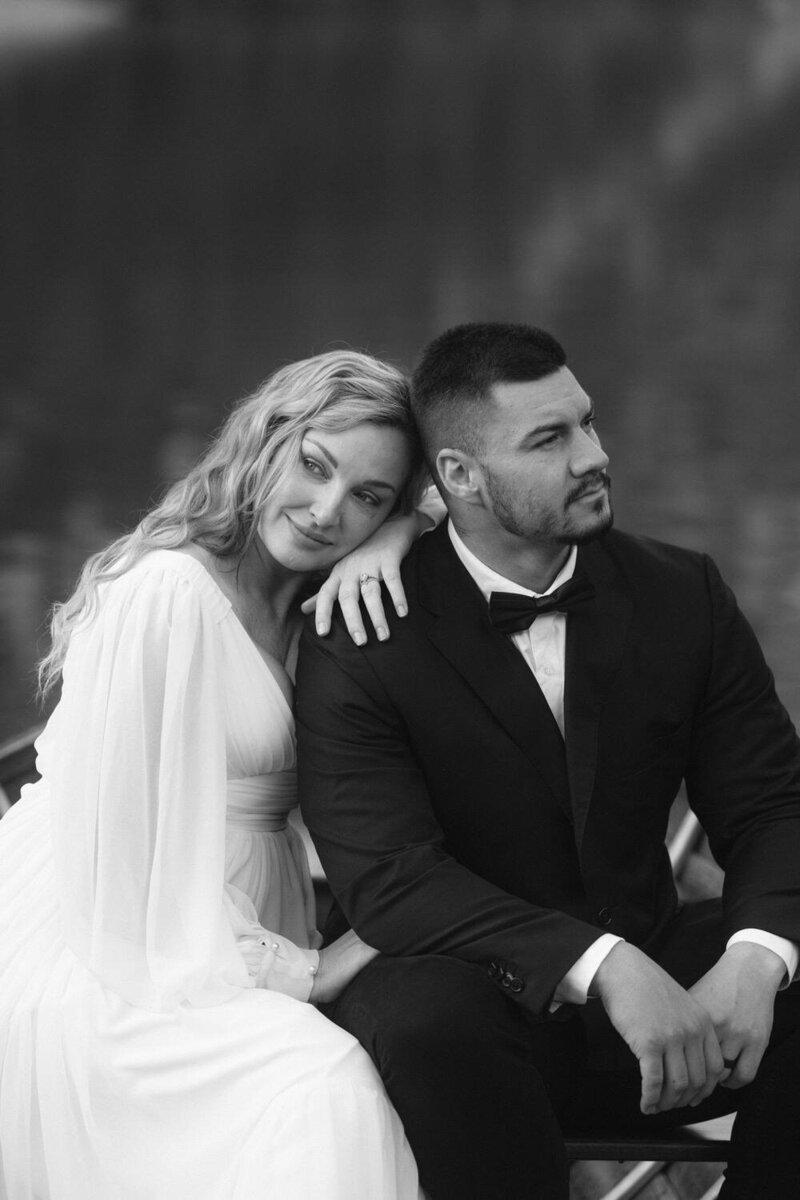 Black and White editorial photo of a bride leaning on her groom during their dolomites elopement 