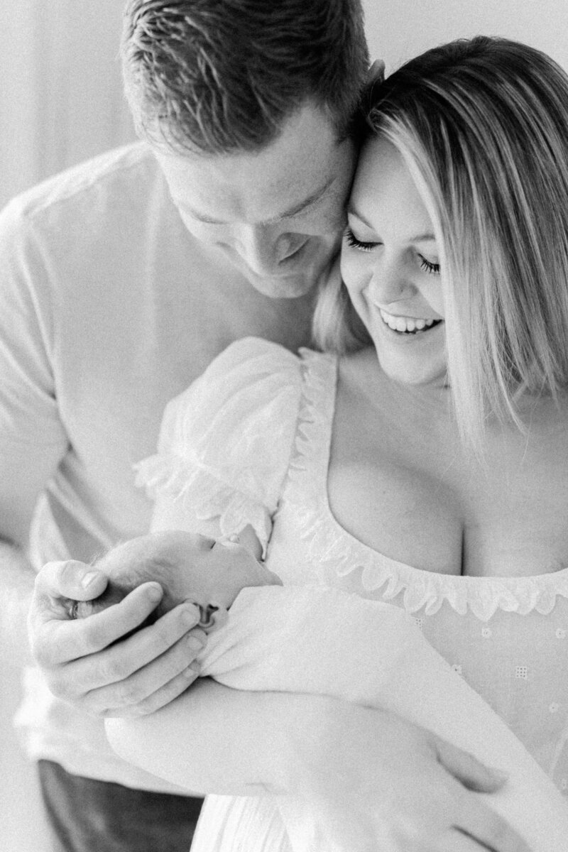 new parents holding newborn by Orlando lifestyle photographer