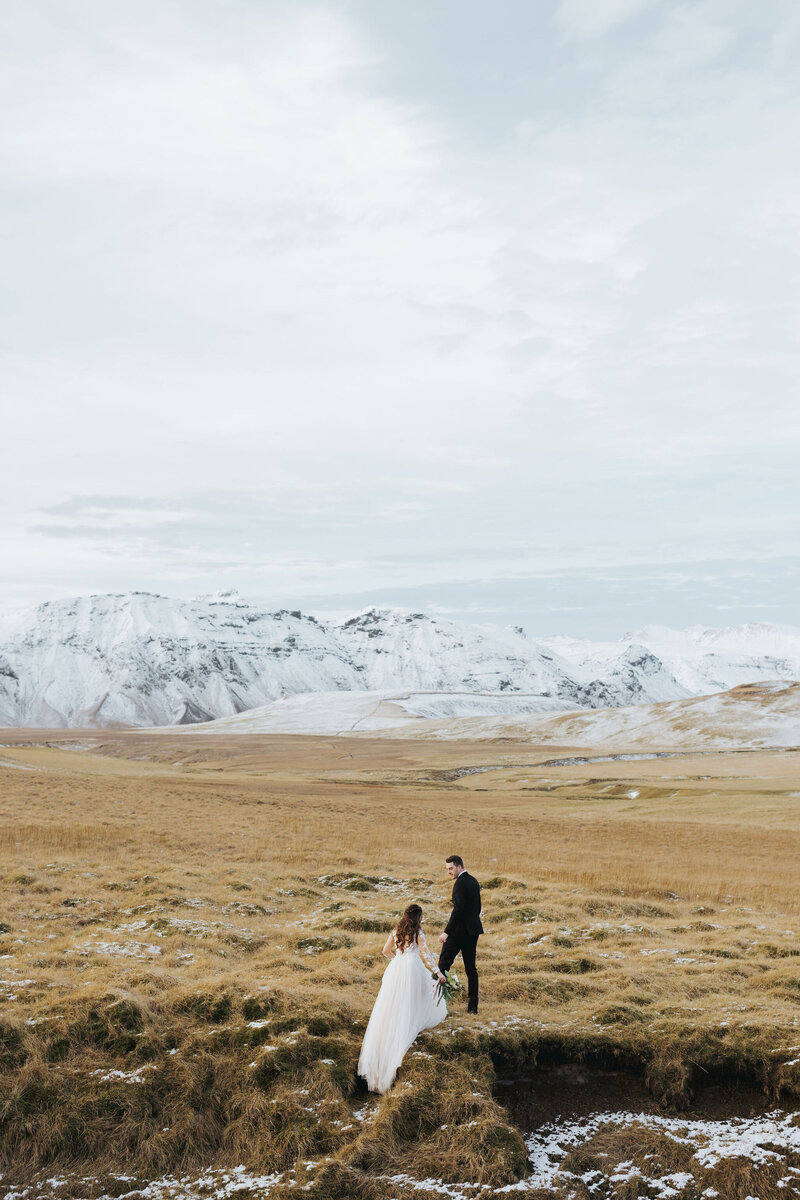 couple posing in field in Iceland