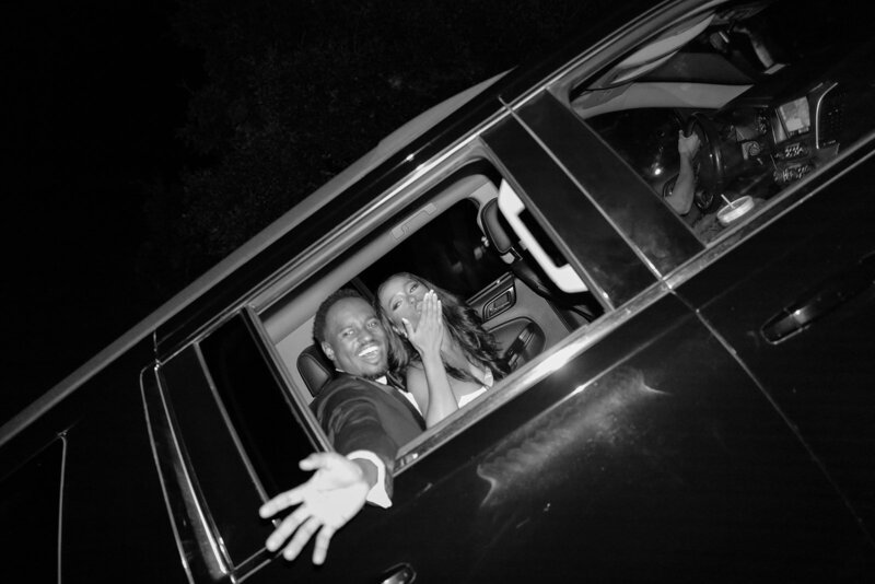 Newlyweds wave goodbye from their getaway car outside The Arlo wedding venue in Austin, surrounded by cheers and celebration.

