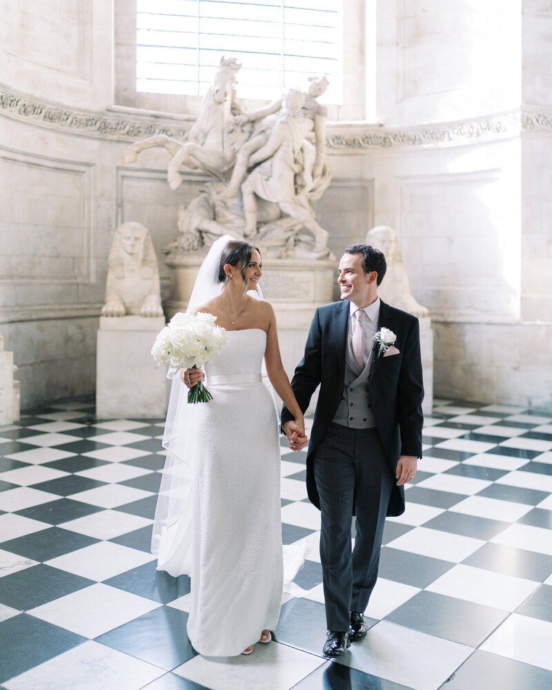 Bride wedding Suzanne Neville gown and groom in tails in St Paul's cathedral.