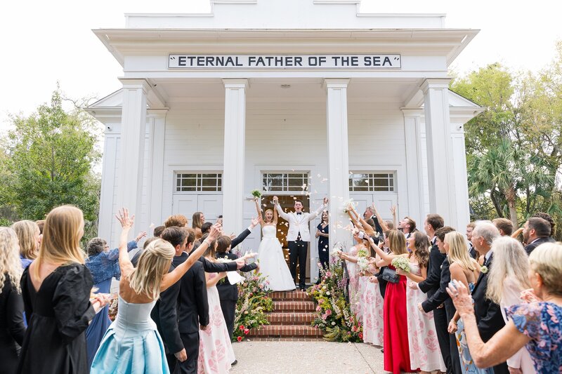 Bride embraces her groom as he smiles