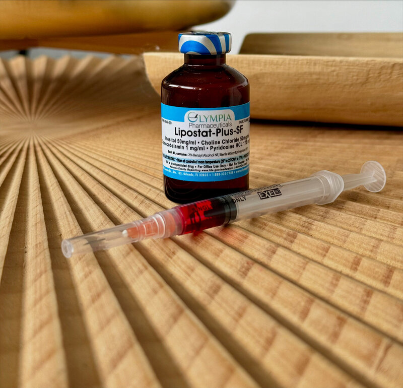 Amber vial next to a needle filled with red liquid