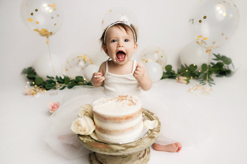 White and gold cake smash photoshoot in Fort Collins, Colorado