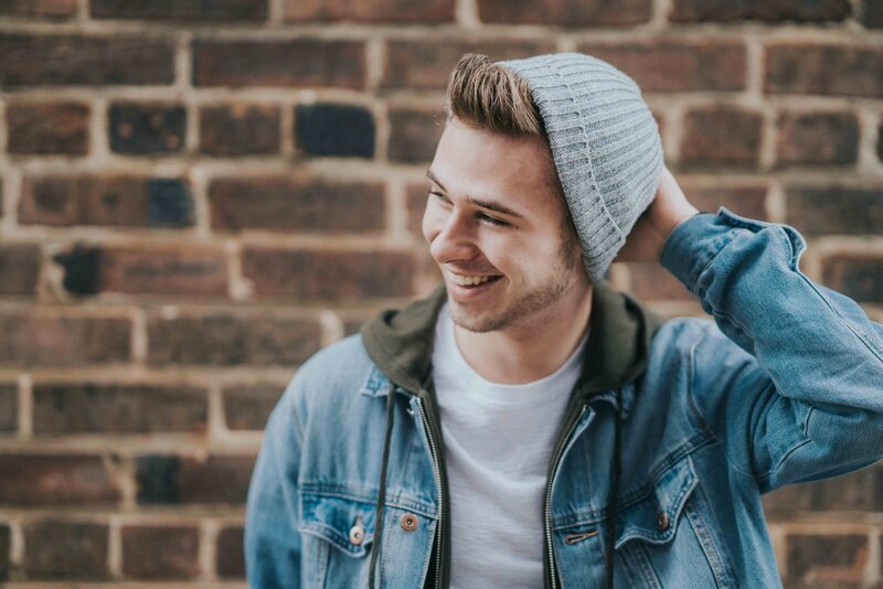 young man with beanie smiling