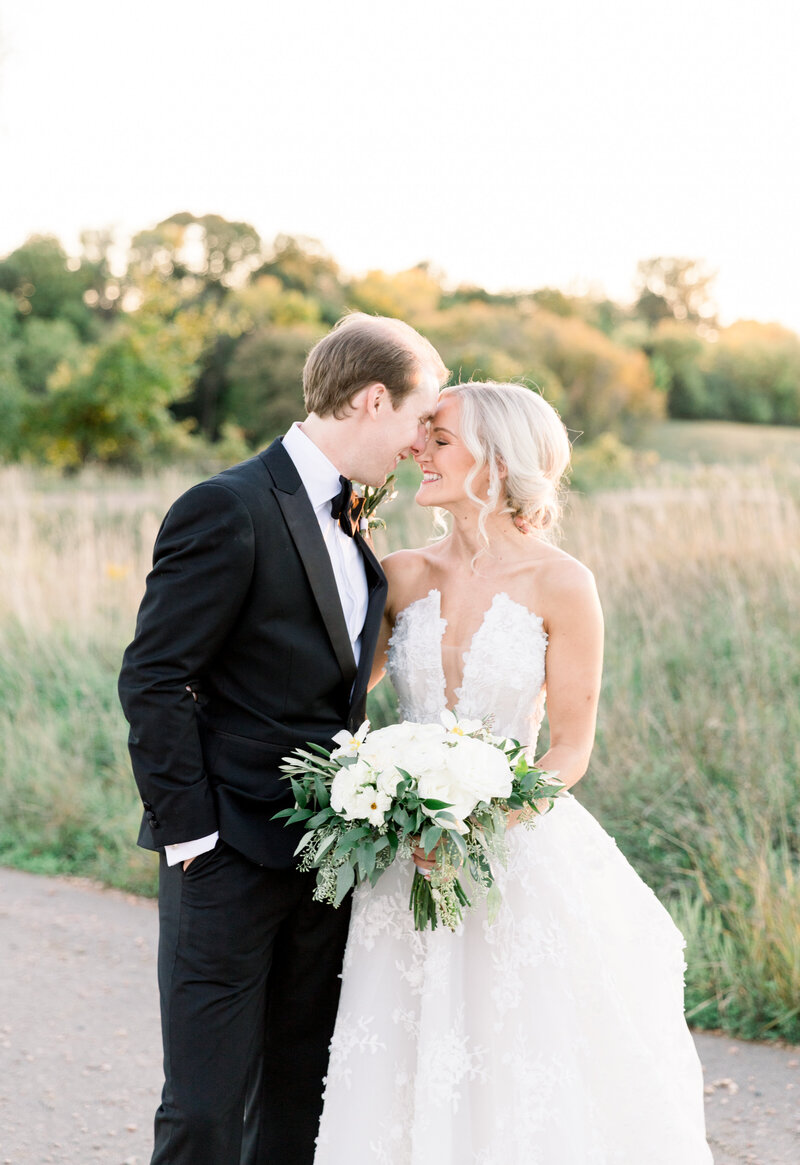 Romantic portrait of couple in white floral wedding gown
