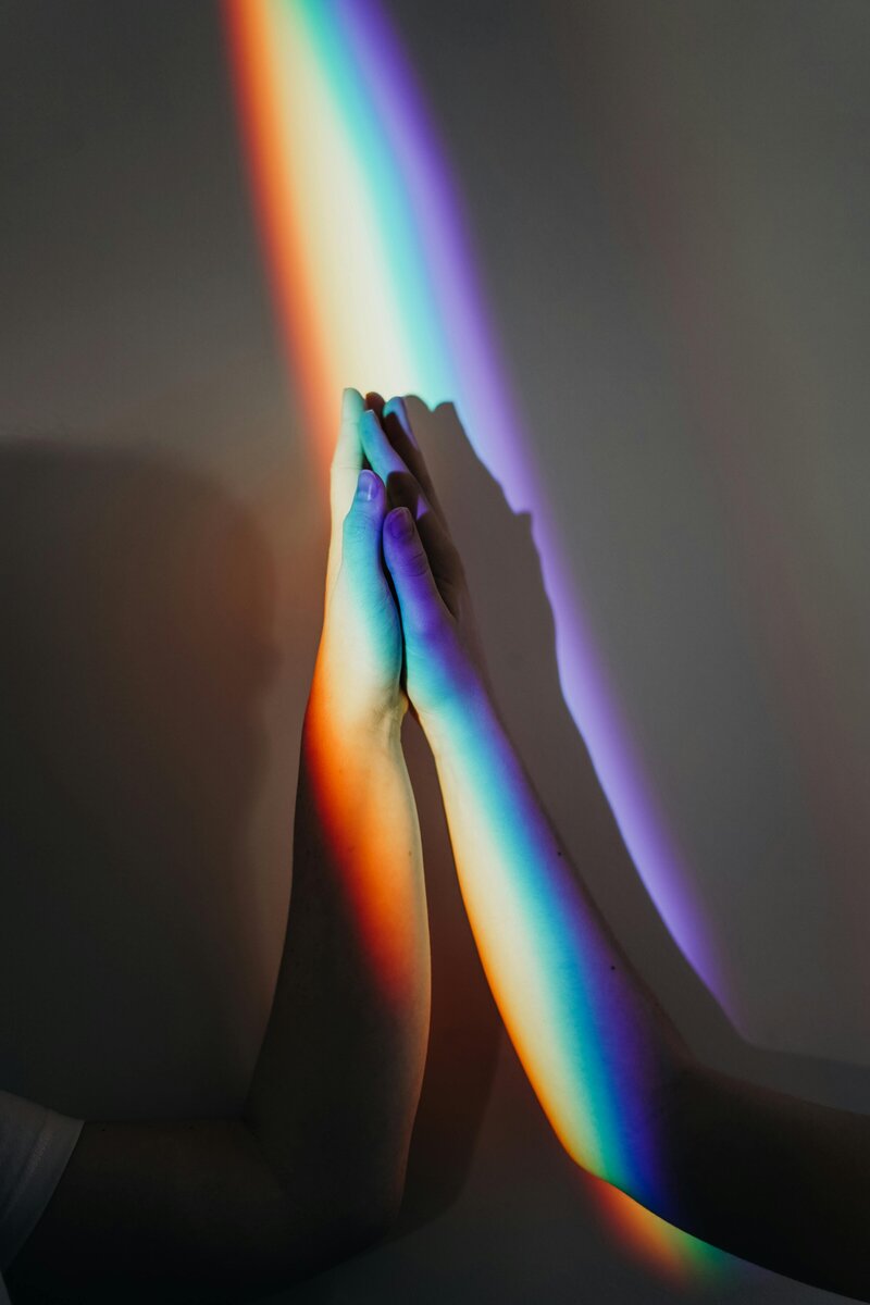 Rainbow light over hands