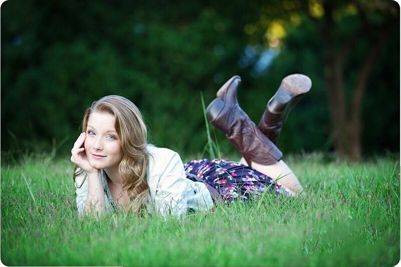 Girl laying in the grass with her feet kicked up