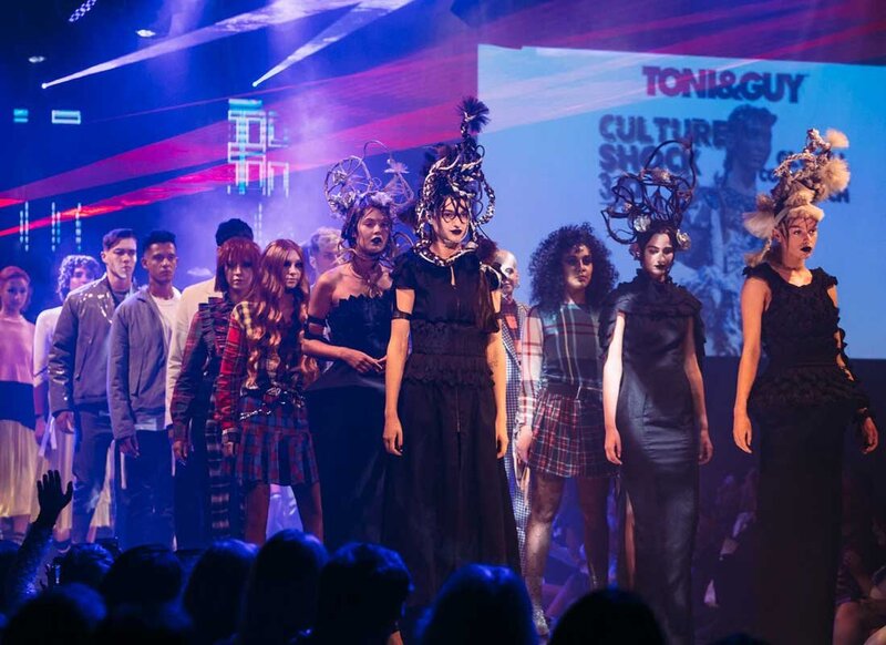 Toni & Guy Culture Shock runway show featuring models in creative hairstyles and dramatic lighting on stage