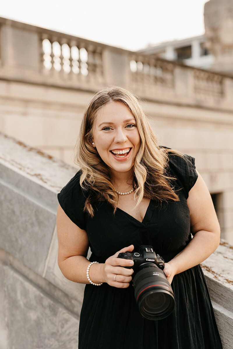 Alexis with her canon camera posing at a venue
