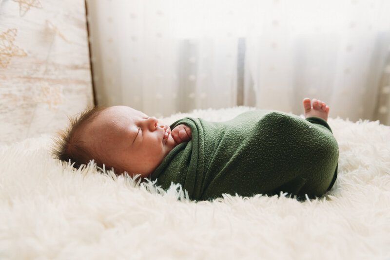 Wrapped up, all snug, a little ones tiny details are captured in a newborn photoshoot in the studio of Nikii Pix Photography.