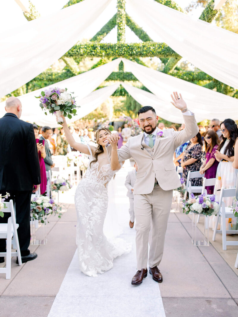 coyote hills wedding venue couple celebrating walking down the aisle after ceremony