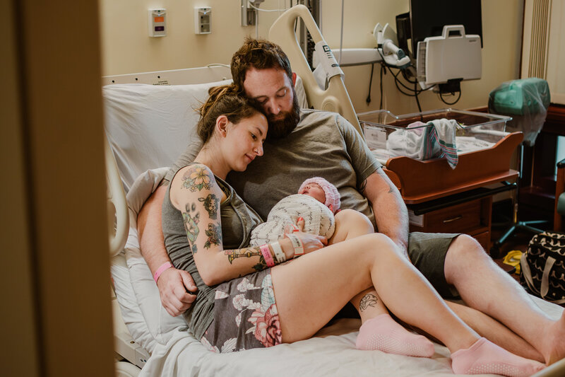 Mom, dad, and new baby in hospital bed for fresh 48 session in Annapolis Maryland