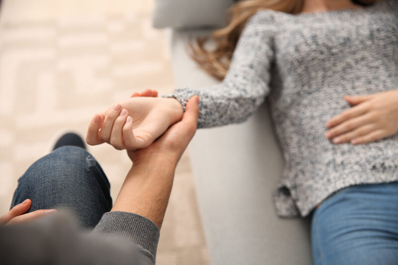 Hypnotist holding a client's wrist
