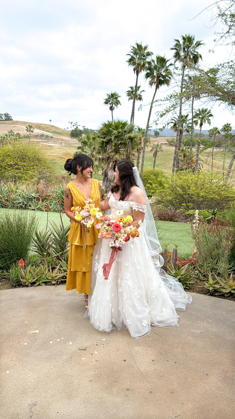 Bride and her bridesmaid wearing a yellow ruffled dress at San Diego Safari Park San Diego Zoo Safari Park.