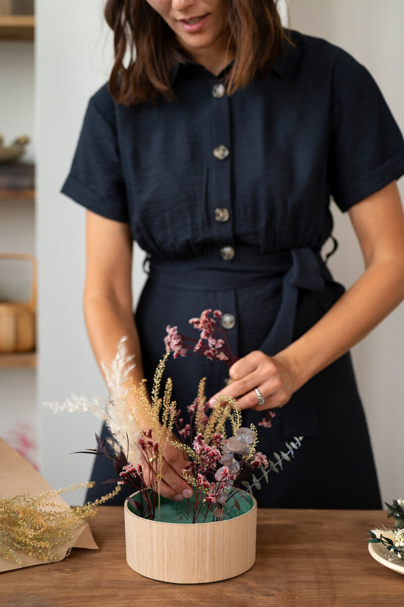 front-view-smiley-woman-working-with-flowers