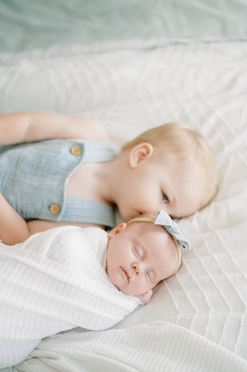 Expectant mother sitting on bed photographed by edmonton maternity photographer, Kahla Kristen