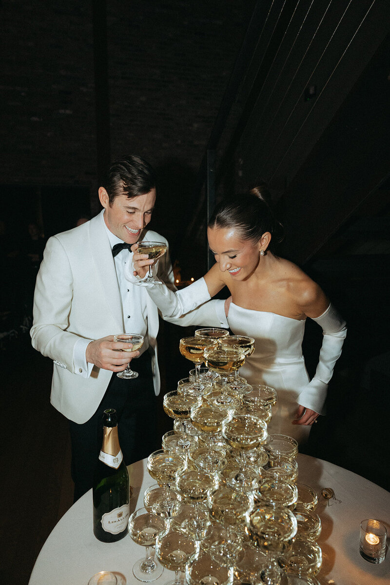 bride and groom with their champagne tower showcasing wedding photography packages and pricing