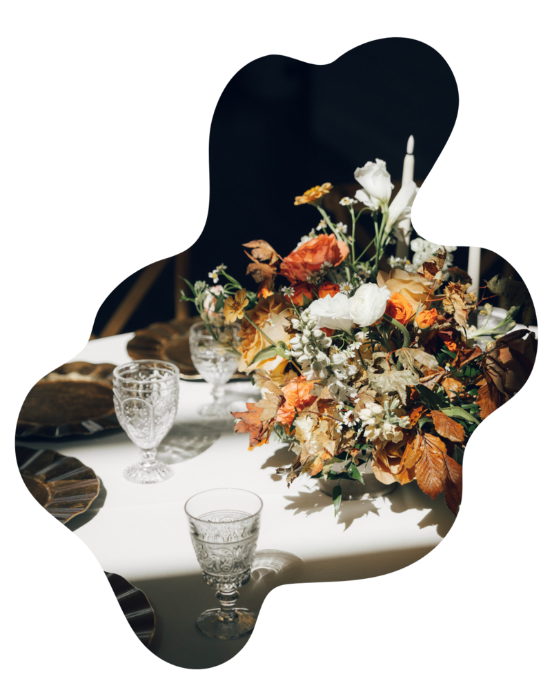 Elegant fall wedding tablescape featuring warm-toned floral arrangements, candles, and seasonal decor by The Floral Eclectic in Dallas