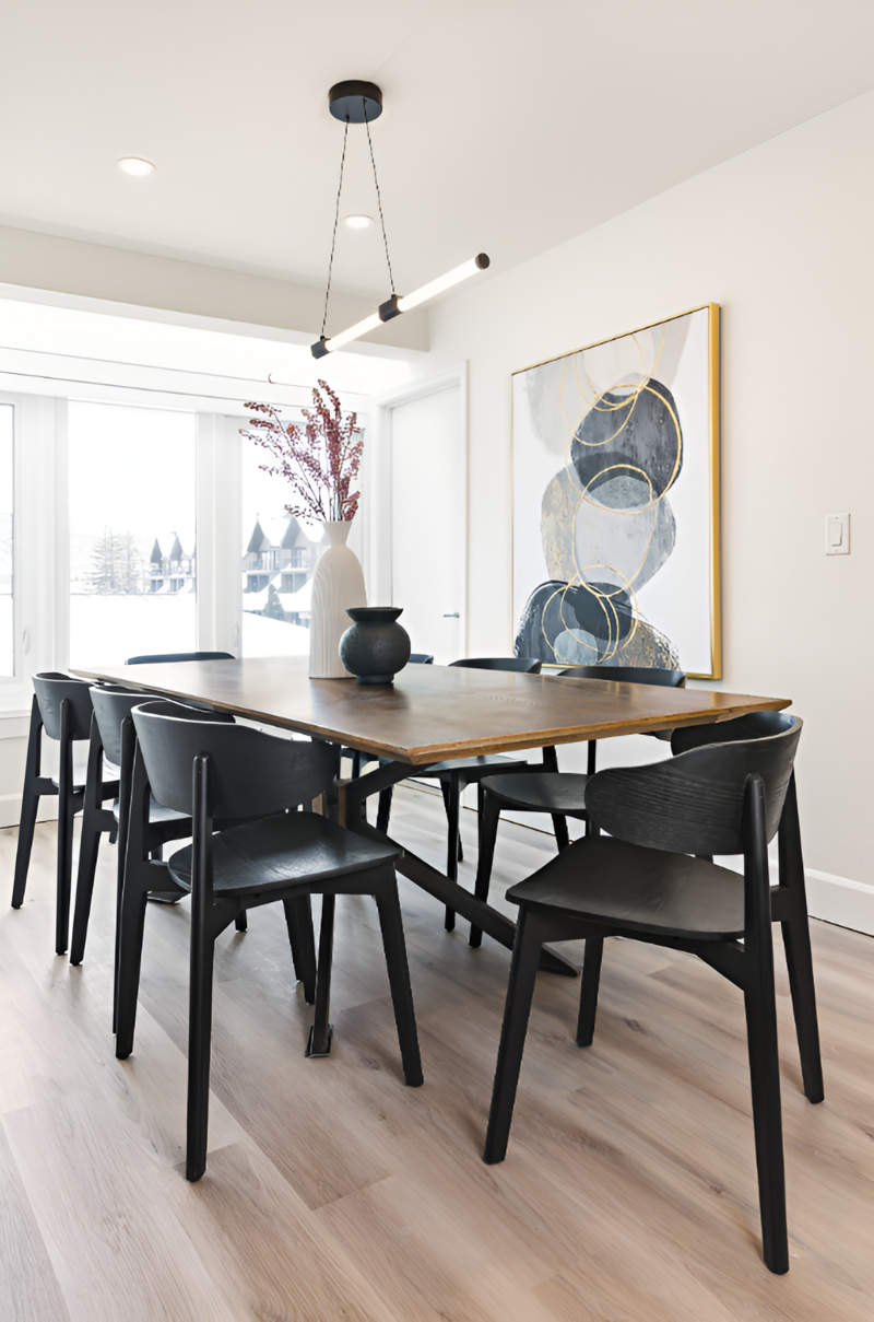 Wide shot of a modern dining room with a industrial furnishings and artful decor in this Park City remodel by Sister Studio