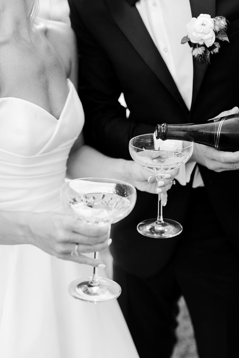 Bride and groom pouring champagne on their wedding day captured by Ohio Wedding Photographer