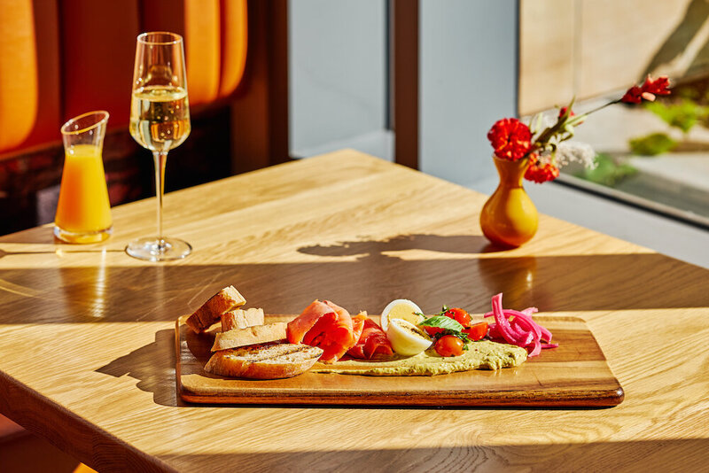 Delectable salmon board paired with a flute of champagne