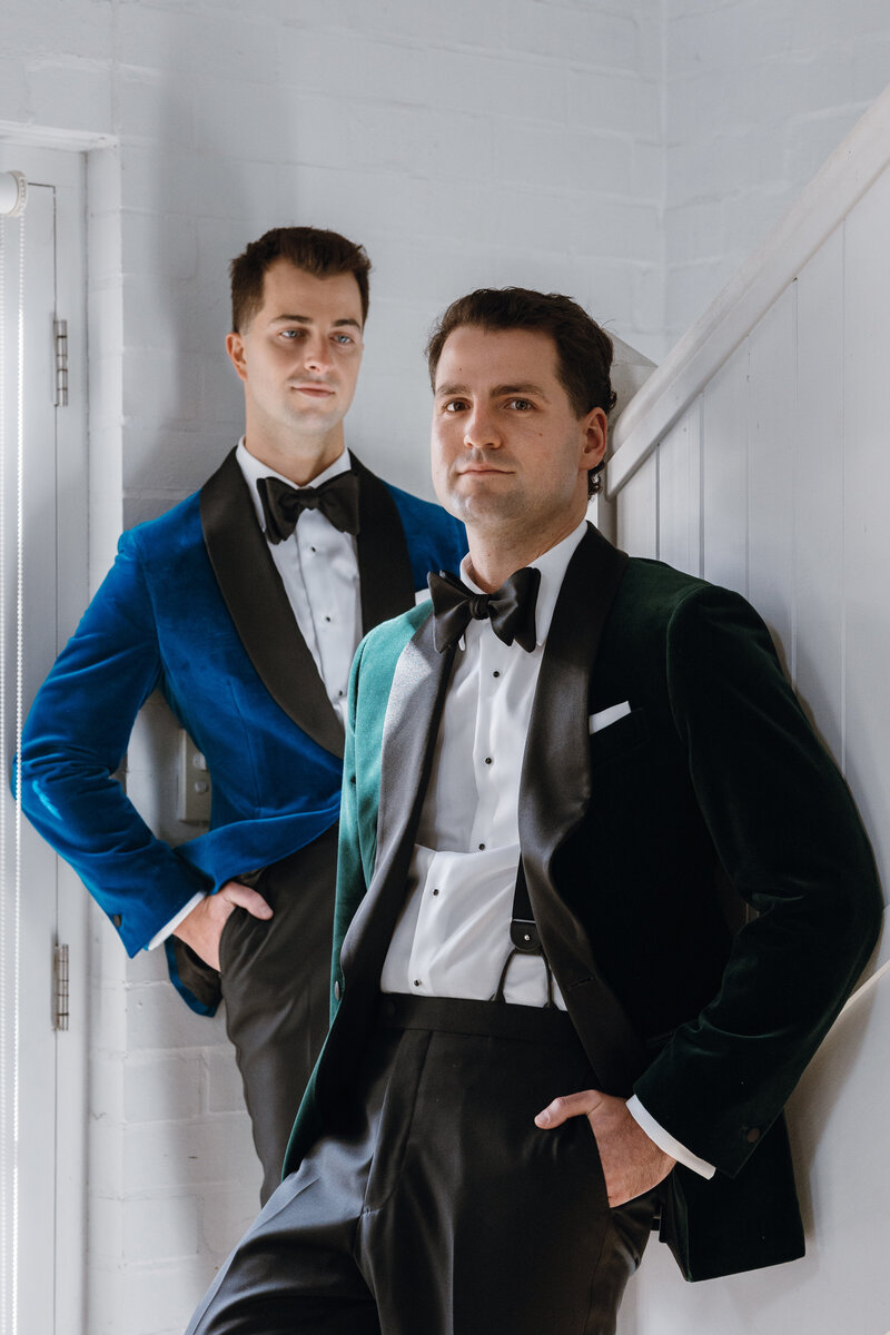 Grooms in their velvet suits after their wedding preparations by the staircase