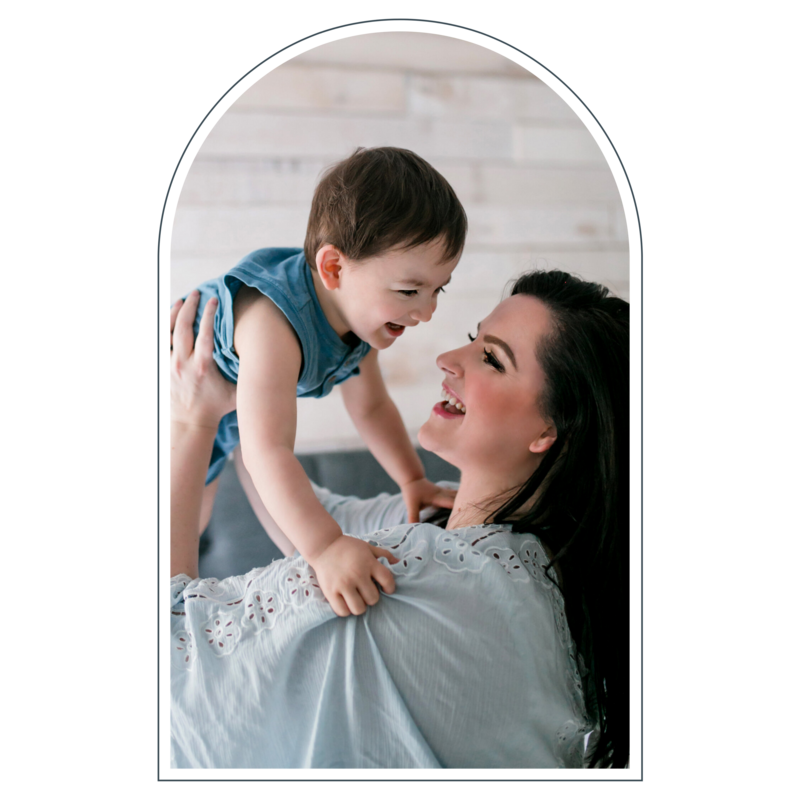 Mother lifting her child playfully, creating joyful candid moments, photographed by a Portland elopement photographer.