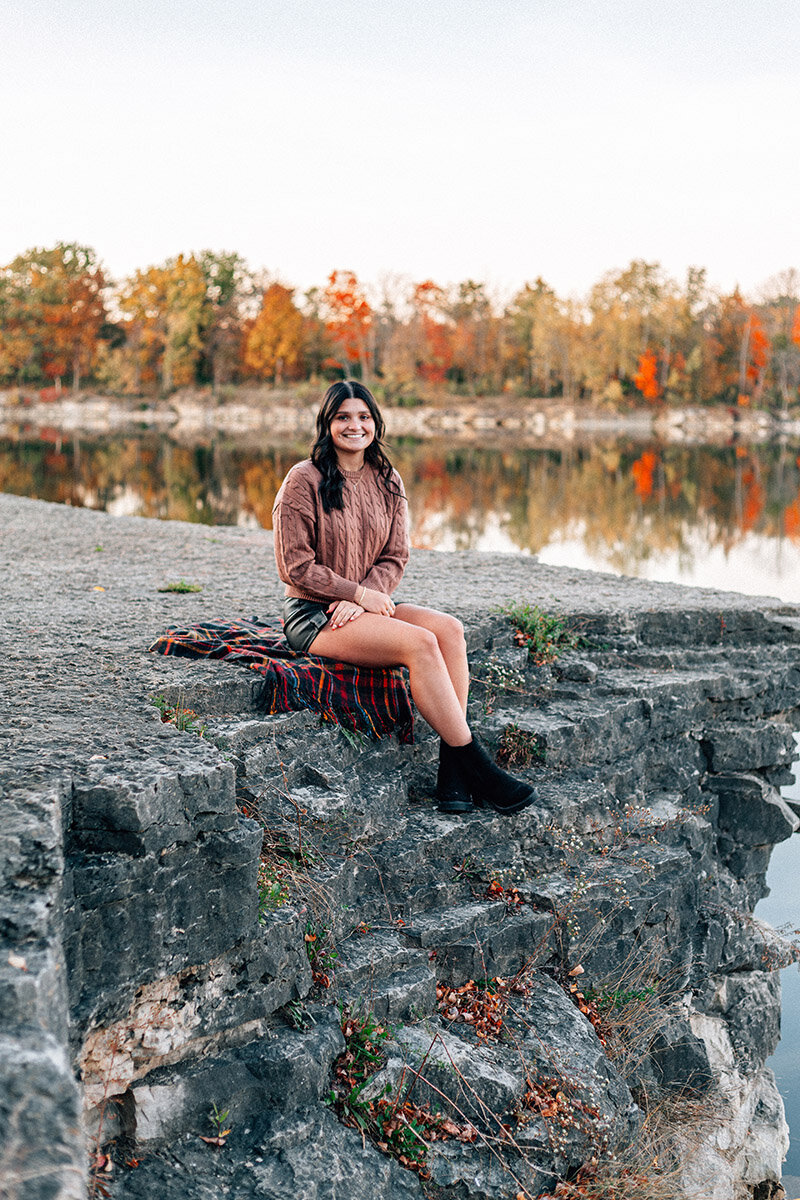 Kayla, a lifestyle photographer based in Lake Geneva, WI, standing confidently in a dark, moody scene, wearing a badass dress that matches her bold, storytelling style.