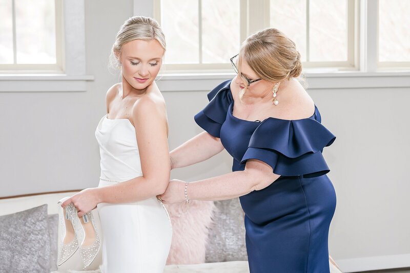 Bride getting into dress with Mom's help | Auburn  Wedding Photographer Amanda Horne