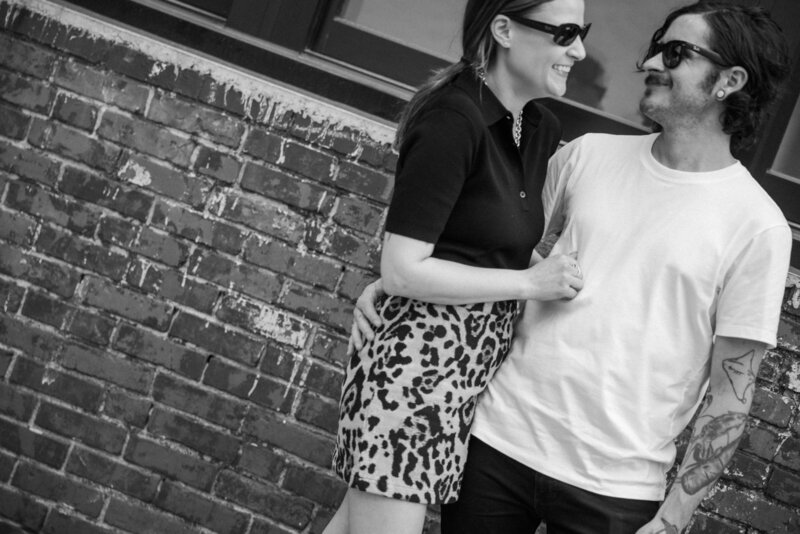 Candid moment of couple laughing during hip Philly photo shoot

