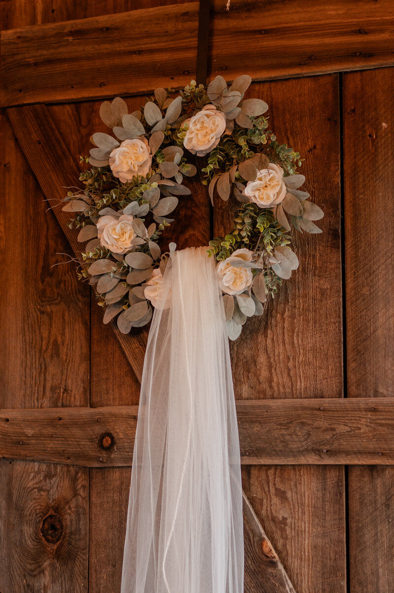 Detail shot of veil and wreath at barn wedding.