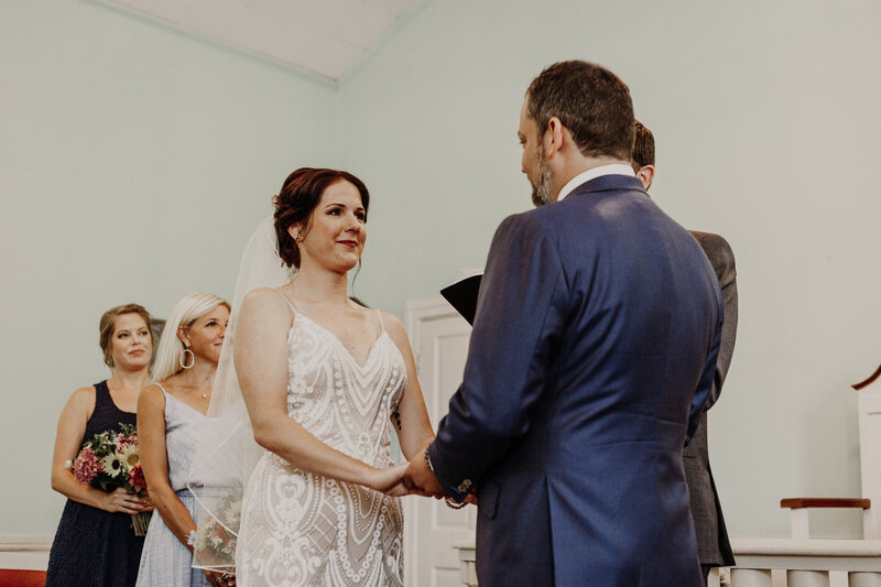 bride looking at groom at altar