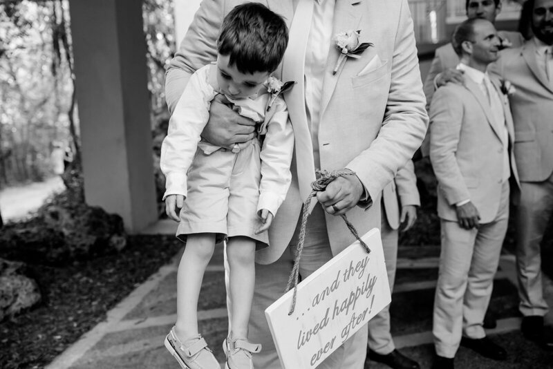 Documentary-Wedding-Photographer-Groom-Carrying-Ring-Bearer