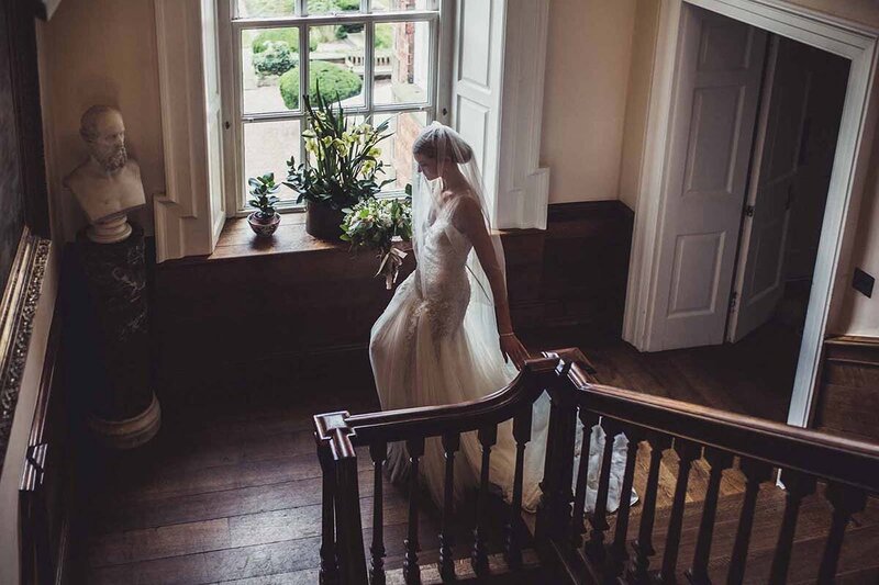 Bride walking down the stairs at Iscoyd Park