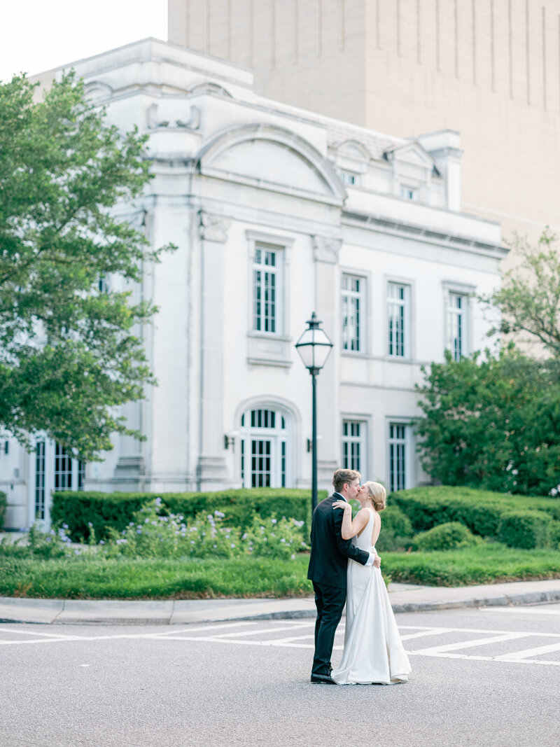 Bride and groom kiss on a Charleston street