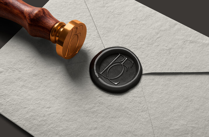 A sealed envelope with a black wax seal stamped “BC” and a wooden and brass stamp beside it, evoking the refined touch of custom Showit web design and branding crafted by an expert Showit designer.