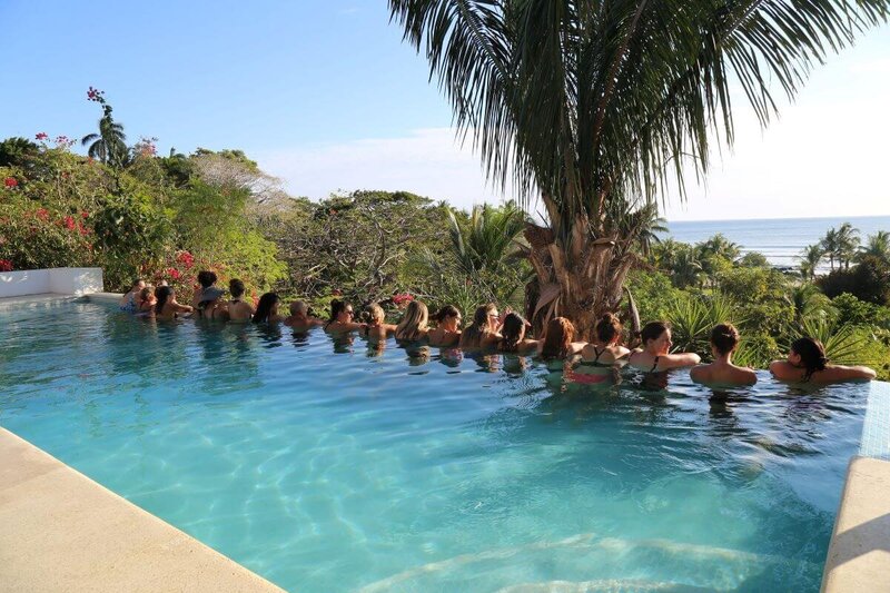 Students enjoying the pool on the yoga deck during 200-hour yoga instructor course in Costa Rica