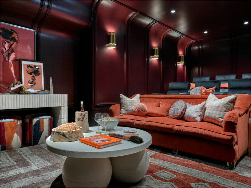 a room with orange, gray, and white furniture